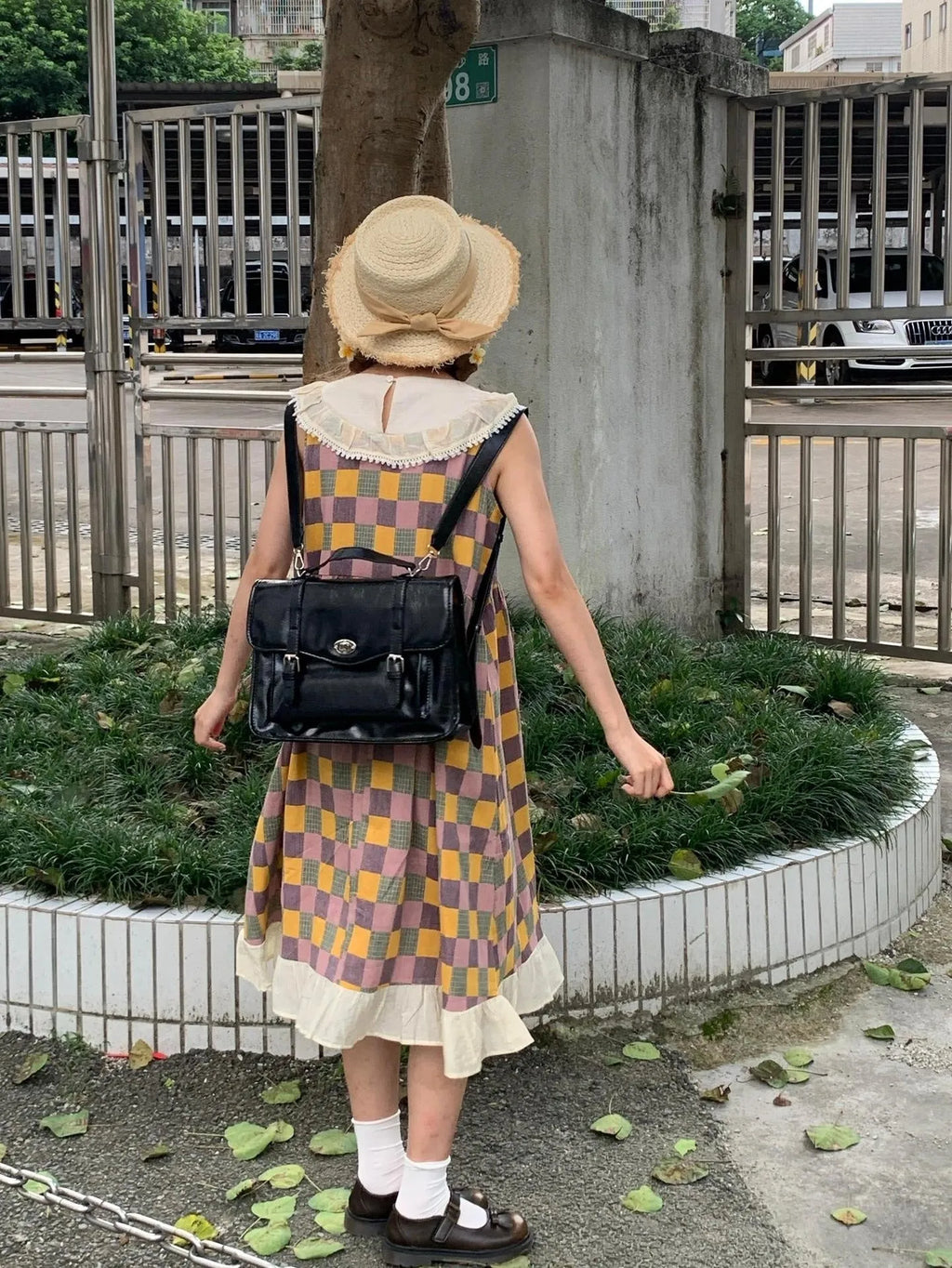 Black college style messenger bag for women made from oil wax leather-look PU material.