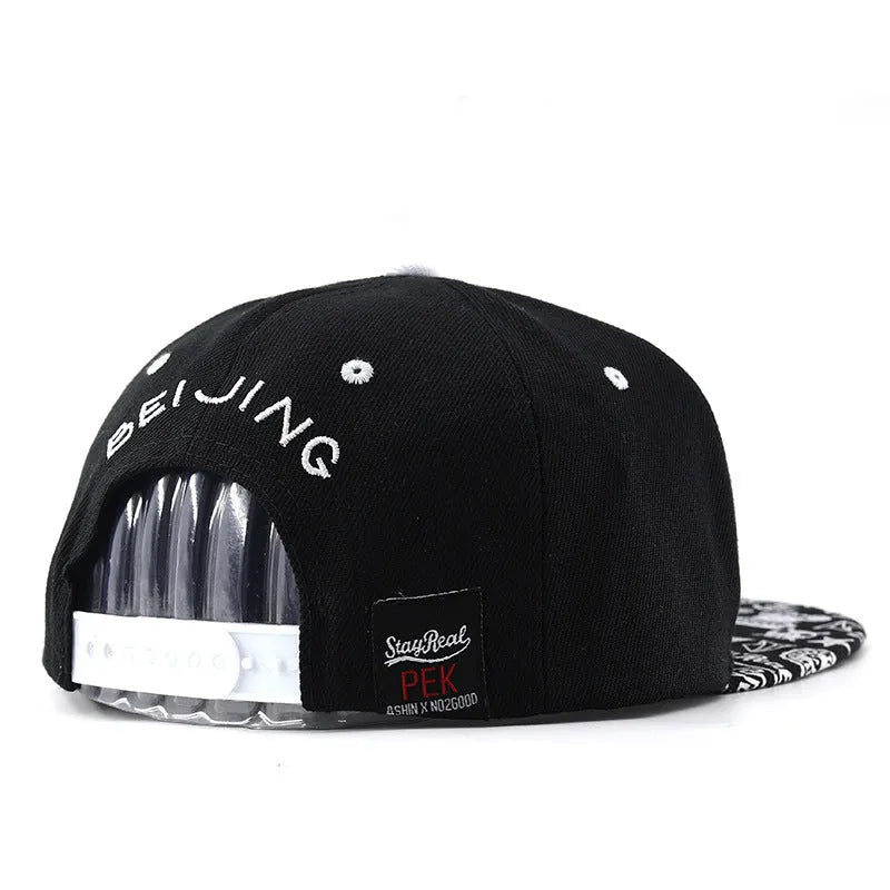 Cotton baseball hat with front letter embroidery in black colour, showing adjustable strap and dome crown.
