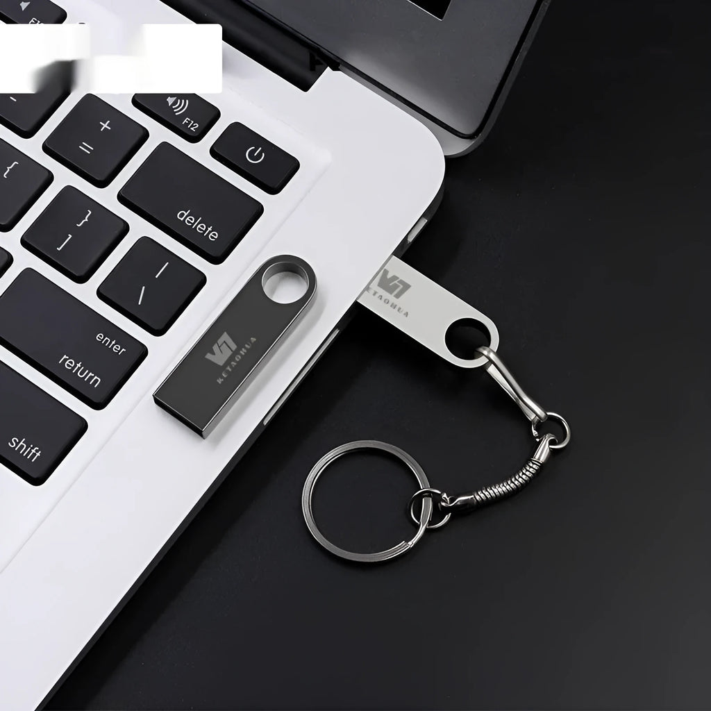 Customisable silver metal car-shaped USB flash drive on a white background.