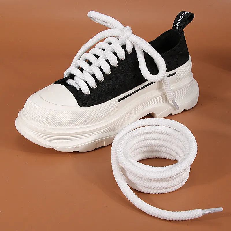 Round white woven shoelace on a grey background showing its 10mm diameter and textured weave.