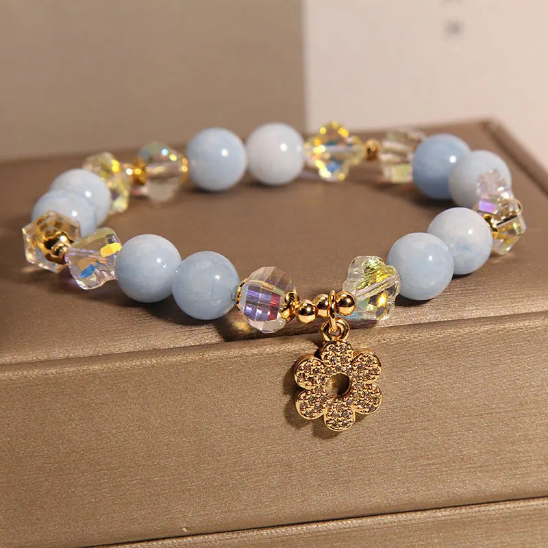 Women's aquamarine crystal bracelet with a four-leaf clover charm and pearl decorative accents