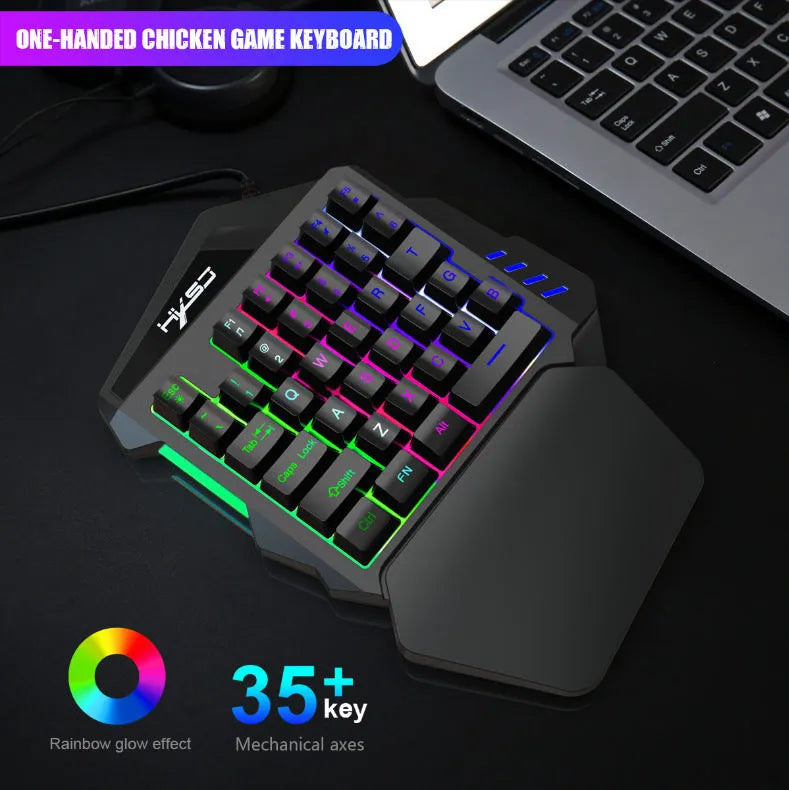 V100 one-handed black mini keyboard and mouse set on a desk