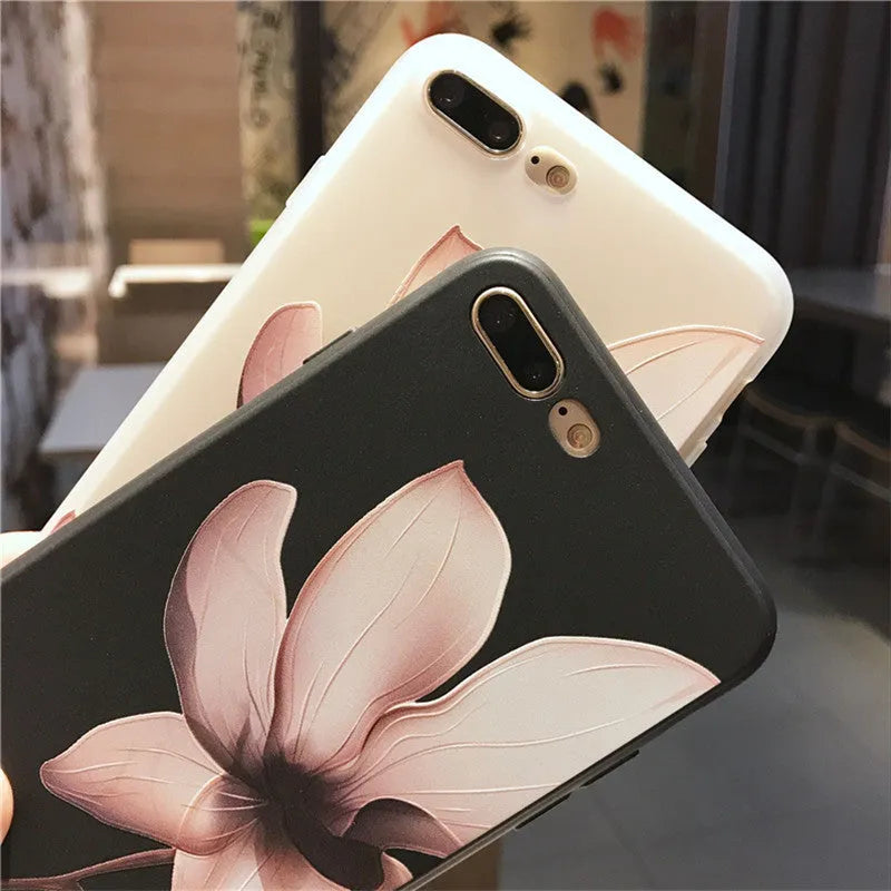 Black TPU iPhone case with a white raised embossed floral pattern on the back.
