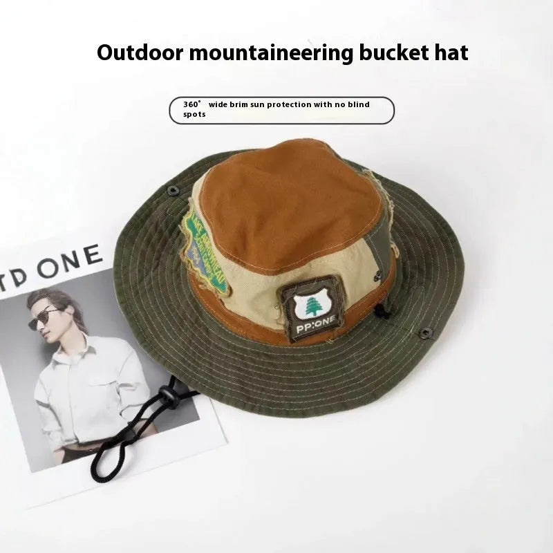 Army green cotton fisherman hat with patchwork design and flat top crown, shown folded for storage