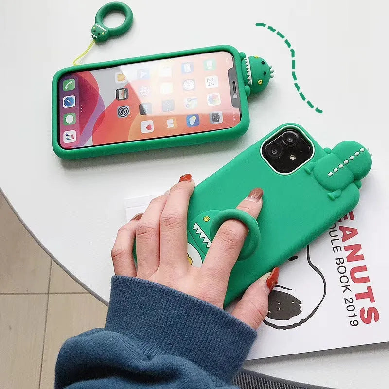 Green and yellow silicone phone cases with cartoon animal designs for Apple iPhones.