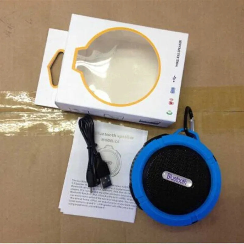 Compact portable Bluetooth stereo speaker with mountaineering buckle, shown in multiple colour options.