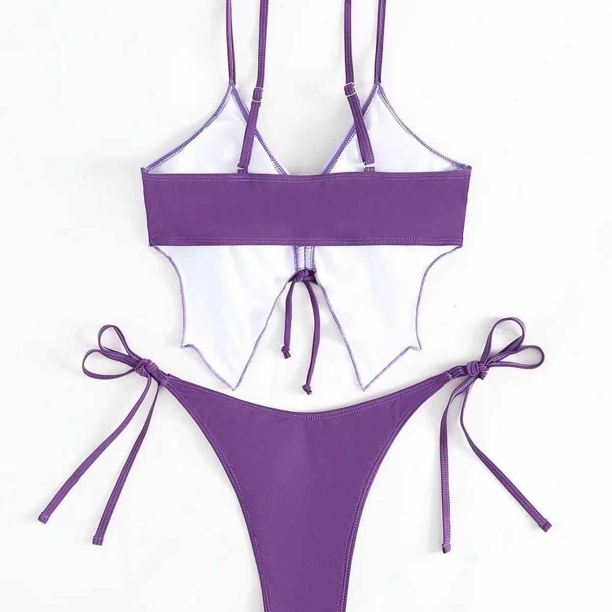 Purple women's bikini suit with bow detail and split design on a mannequin.
