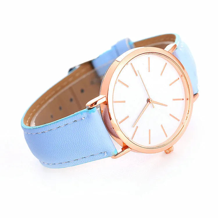 Women's quartz wristwatch round dial 28mm thin case beige strap on white background