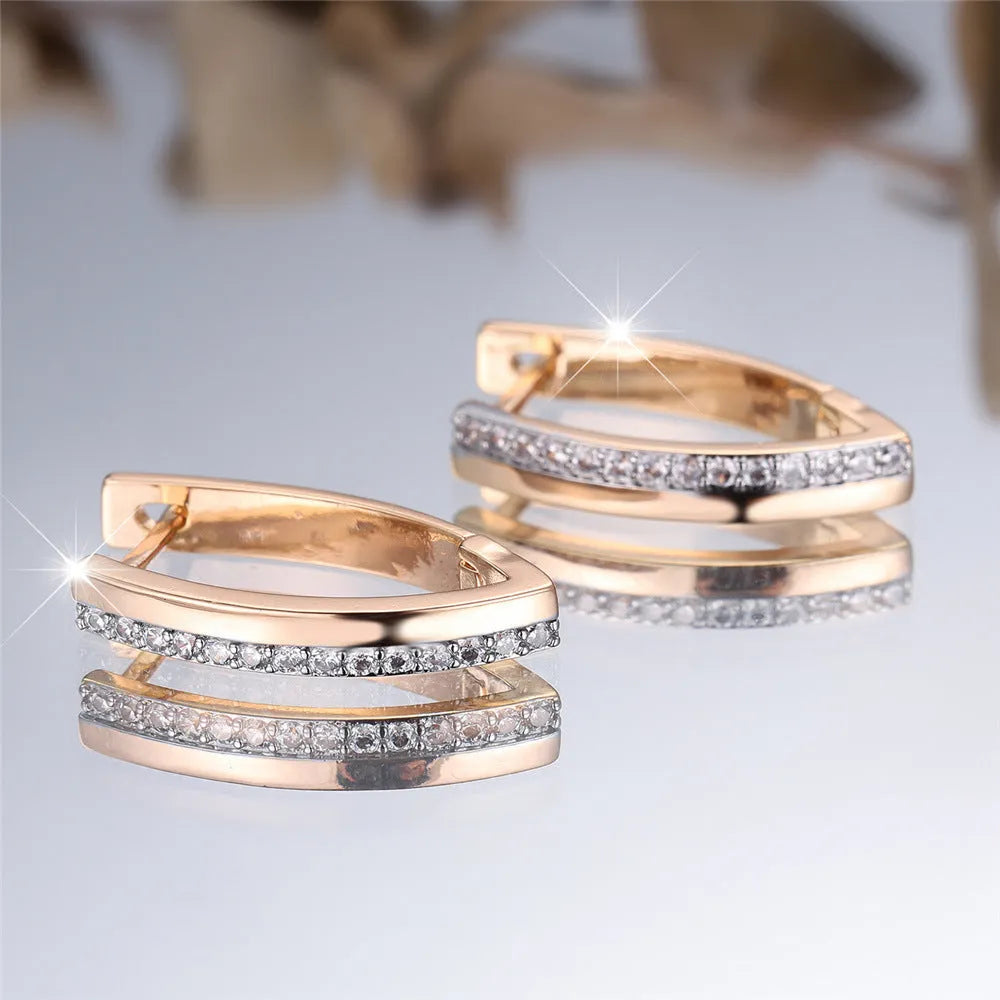 Geometric V-shaped women's earrings in champagne gold white diamond colour.