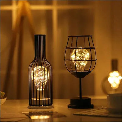Minimalist hollow wrought iron table lamp in red wine glass style with warm white LED light.