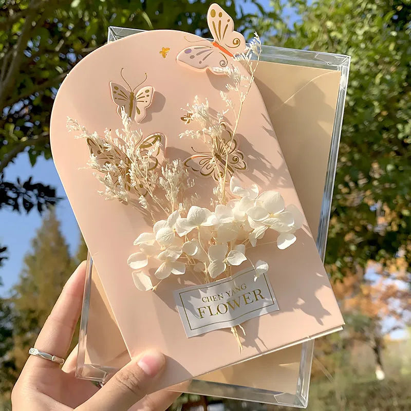 Handmade 3D butterfly-shaped birthday card with artificial flowers and hot foil stamping details.