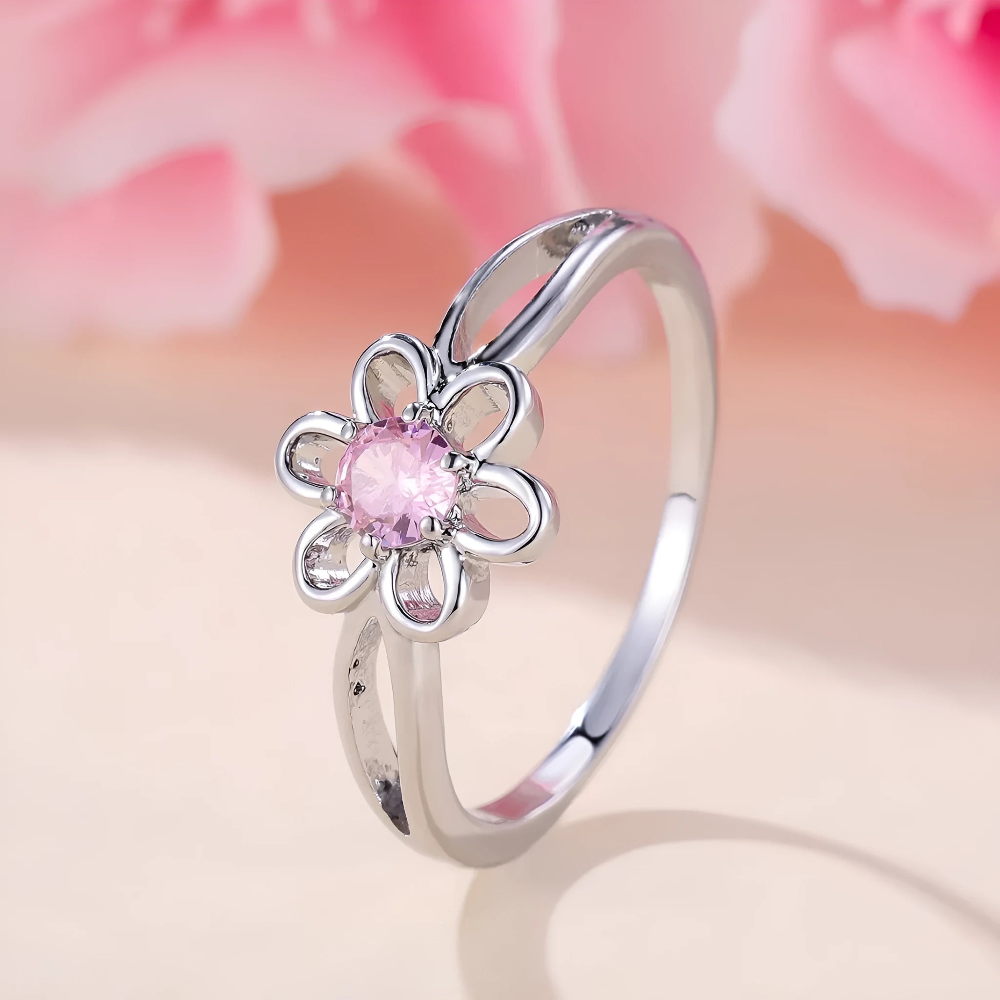 Women's hollow floral fashion ring in copper with electroplated finish, shown in platinum pink diamond colour.