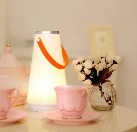 White rechargeable LED bedside night light with touch controls showing compact 12cm square design