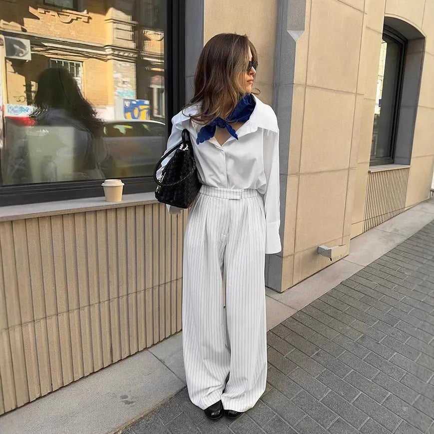 Women's white striped wide-leg trousers with side zip on mannequin