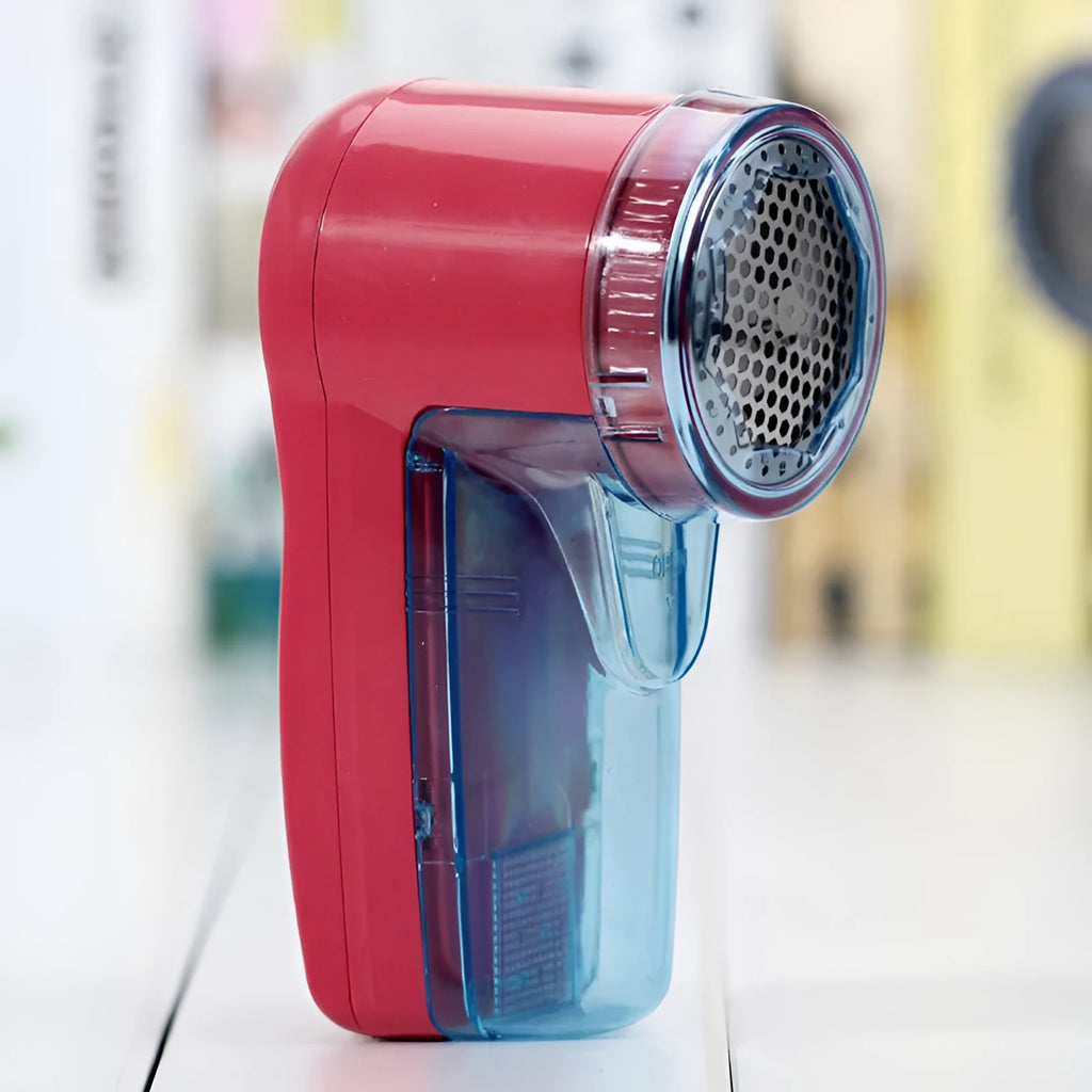 Portable electric lint remover handheld device on a blue background.