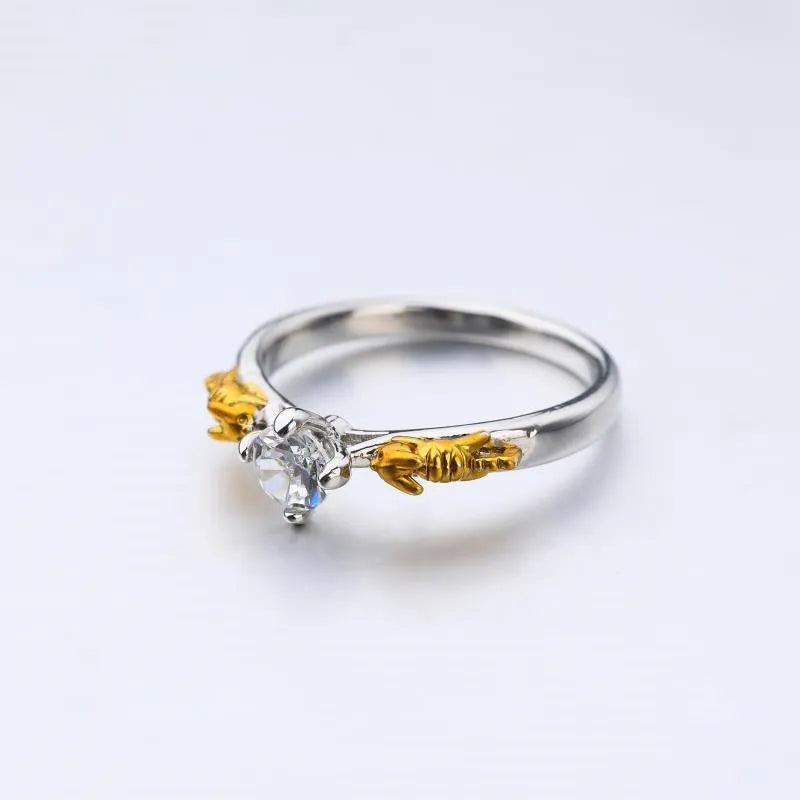Copper crown fashion ring with black gold crystal centrepiece shown in individual packaging