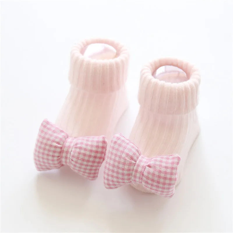 Cotton baby floor socks in blue bow pattern for infants 0-3 months.