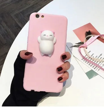 Soft silicone iPhone case with a raised 3D cartoon cat design, shown in pink.