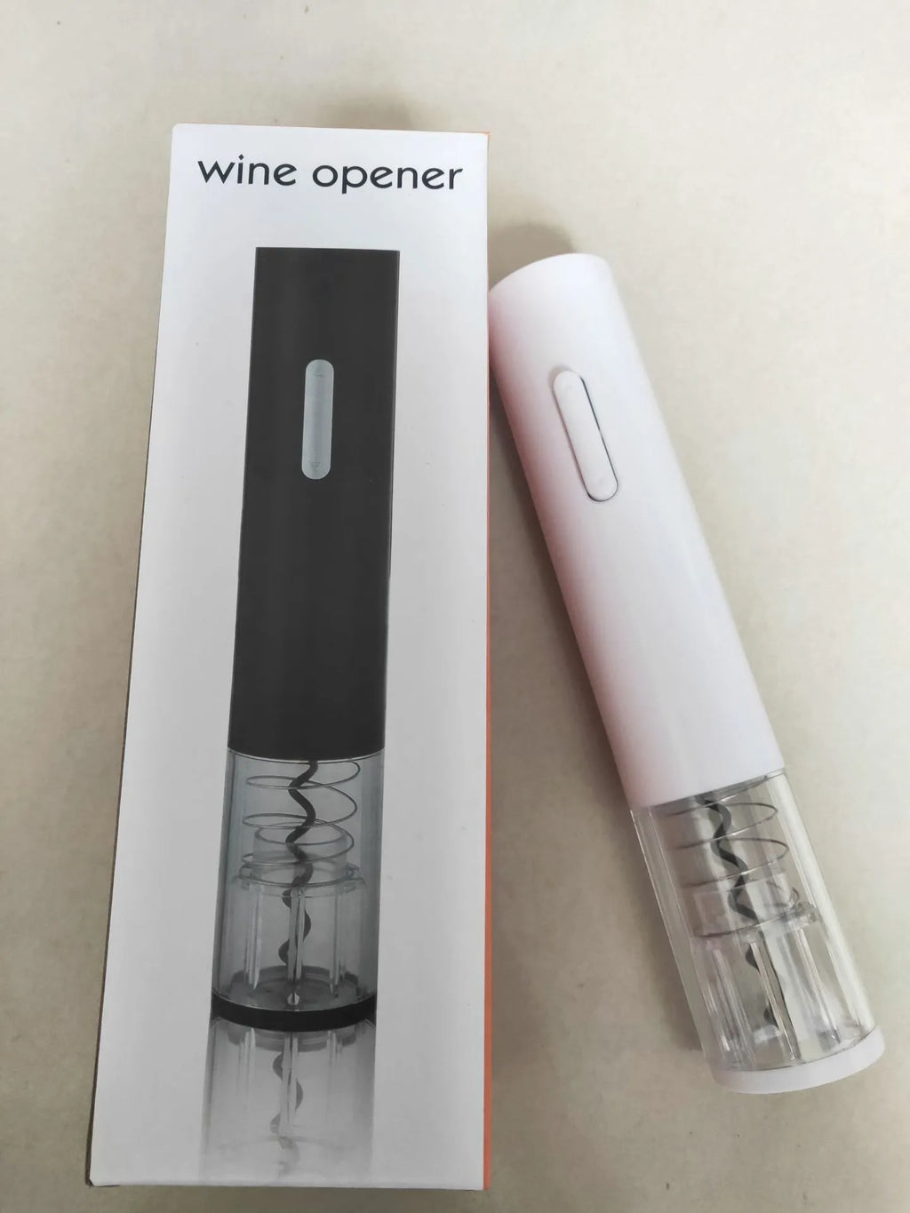 Black electric wine bottle opener with foil cutter showing automatic corkscrew mechanism
