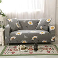 Geometric patterned stretch sofa slipcover fitted on a three-seater sofa in a living room.
