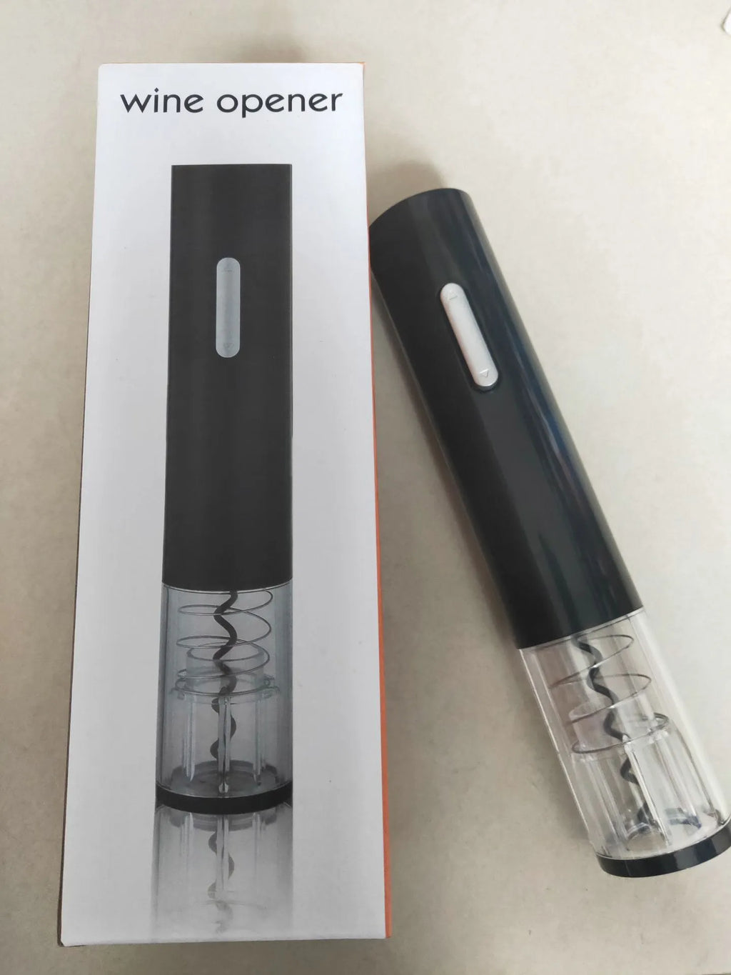 Black electric wine bottle opener with foil cutter showing automatic corkscrew mechanism