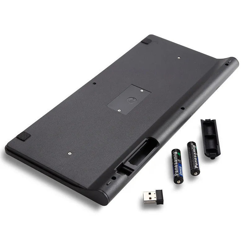 Black and white wireless keyboard and mouse set on a wooden desk