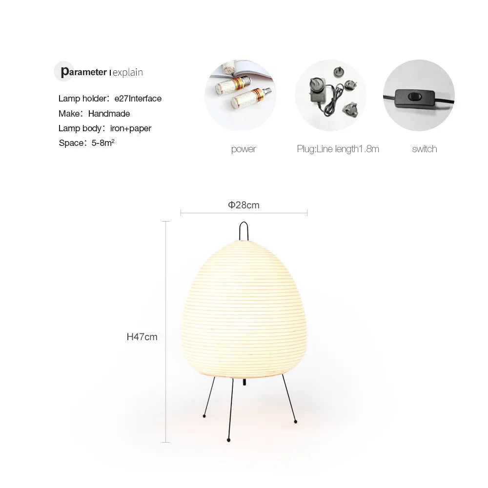 Japanese style handmade rice paper table lamp with an aluminium base on a wooden table.