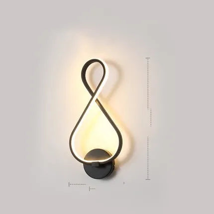 Nordic minimalist LED wall lamp with silicone shade in black finish mounted beside bed