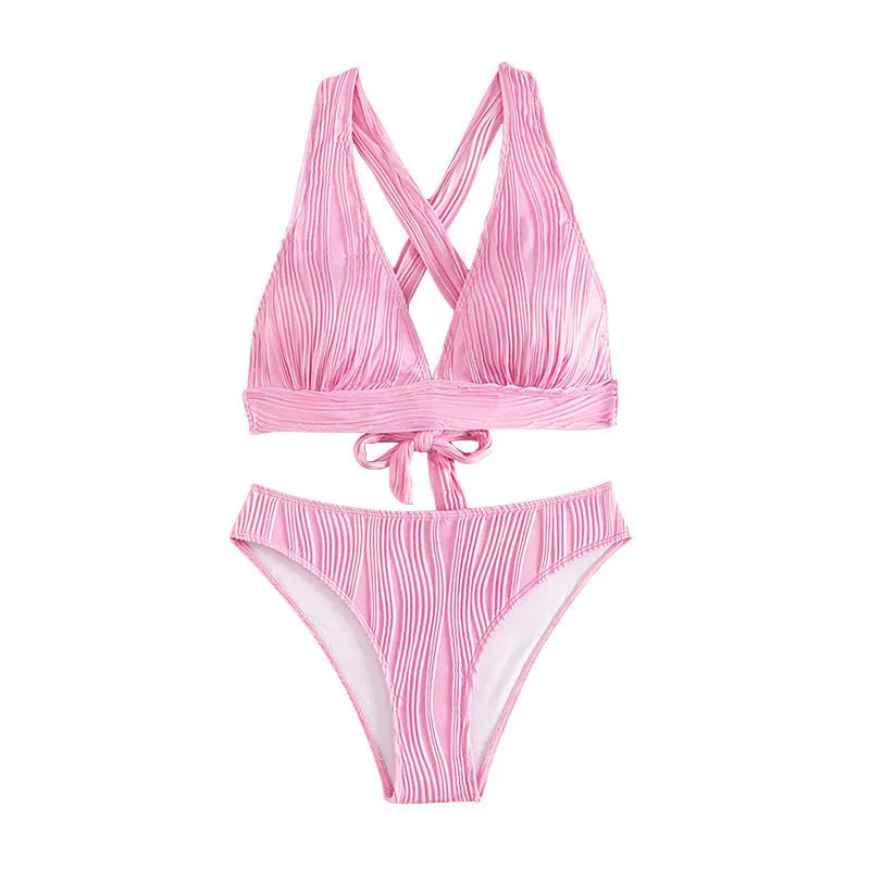 Women's pink halter strap bikini set with split shorts on mannequin display