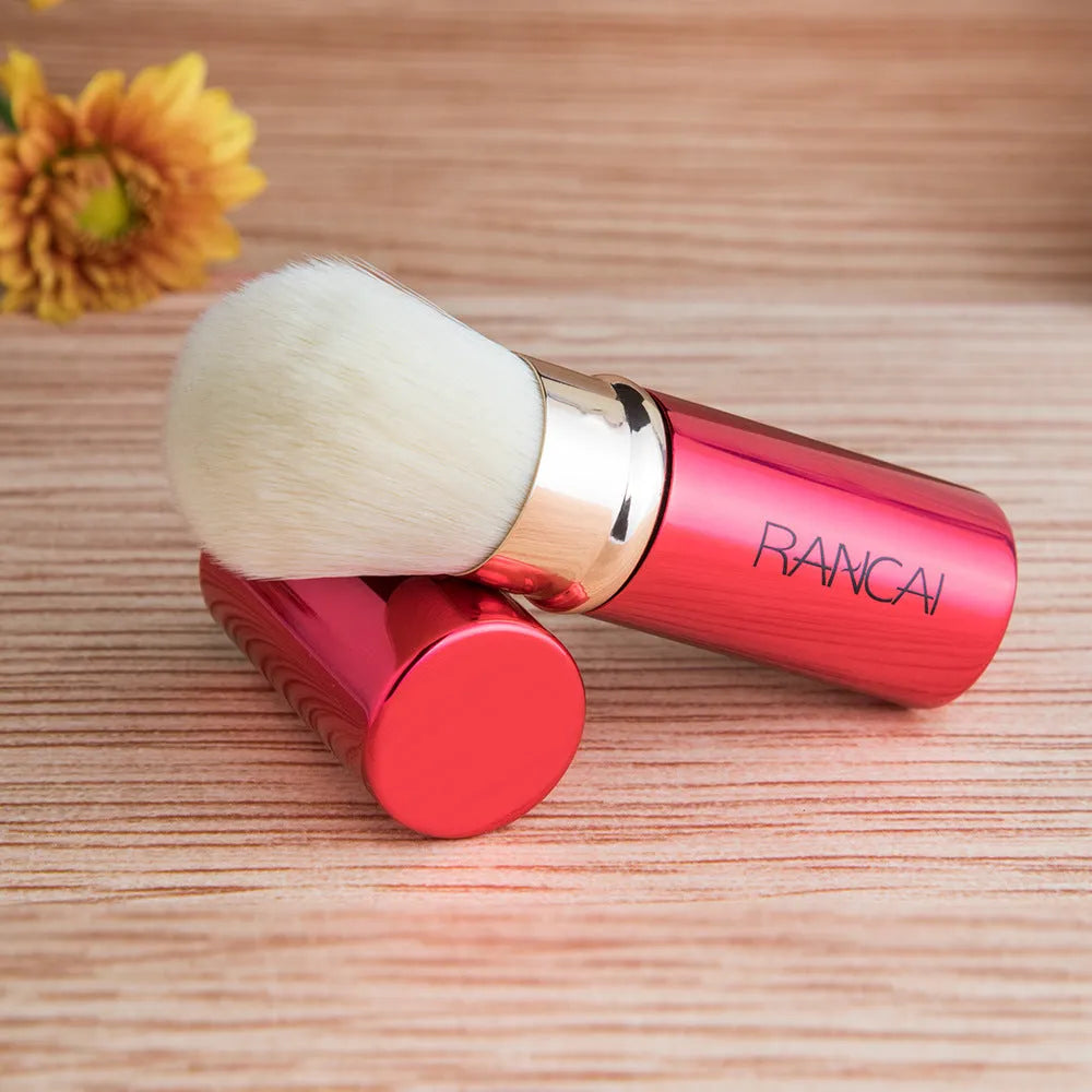 Single mini retractable makeup brush with aluminium tube and fibre wool bristles, 9cm long, available in black or red