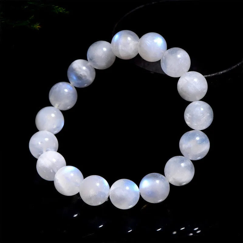 Natural blue moonlight round bead moonstone bracelet showing polished geometric beads on wrist
