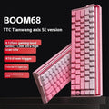 Boom68 compact mechanical gaming keyboard with RGB backlighting on a desk, showing its 68% layout and Gradient Pink colourway.
