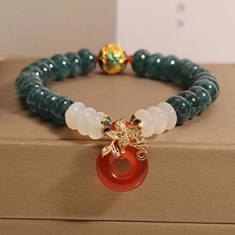 Blue water jade and red agate bracelet with crystal beads and a peace buckle closure