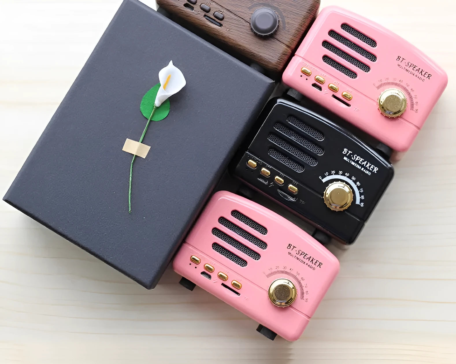 Compact vintage wood finish Bluetooth speaker in black, pink, or wood grain colour