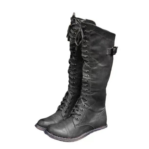 Women's black high leg boots with a chunky low heel and round toe on a solid background.