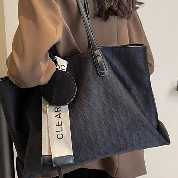Soft large casual shoulder tote bag in a horizontal square shape with a sandwich pocket and sewing thread detail.