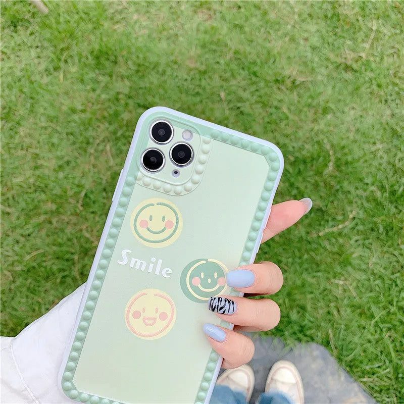 Green iPhone case with geometric polka dot frame and smiley face design for multiple iPhone models
