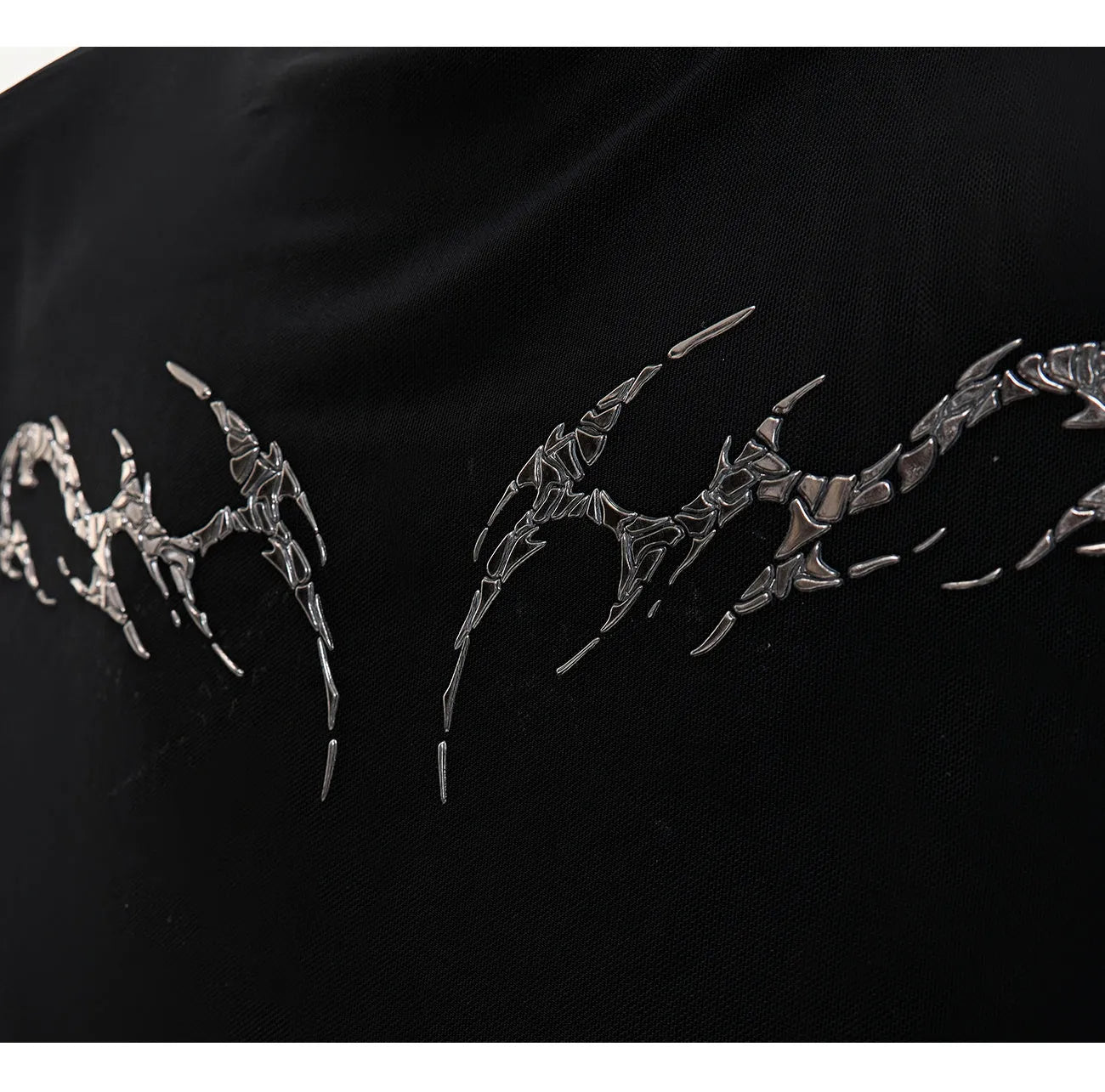 Black niche mesh slim-fit long sleeve bottoming shirt laid flat, showing trendy style and texture.