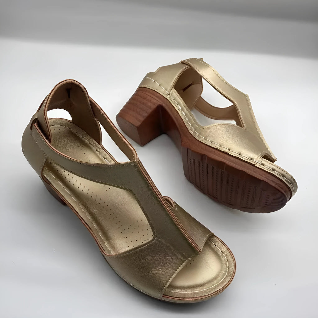 Women's white peep toe wedge sandals with a buckle and low heel on a neutral background.