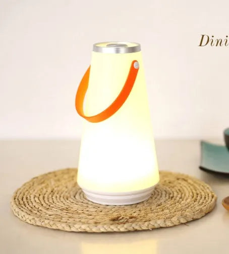 White rechargeable LED bedside night light with touch controls showing compact 12cm square design