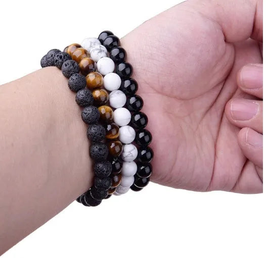 Women's black onyx bead bracelet with geometric design on a stretchy elastic cord.