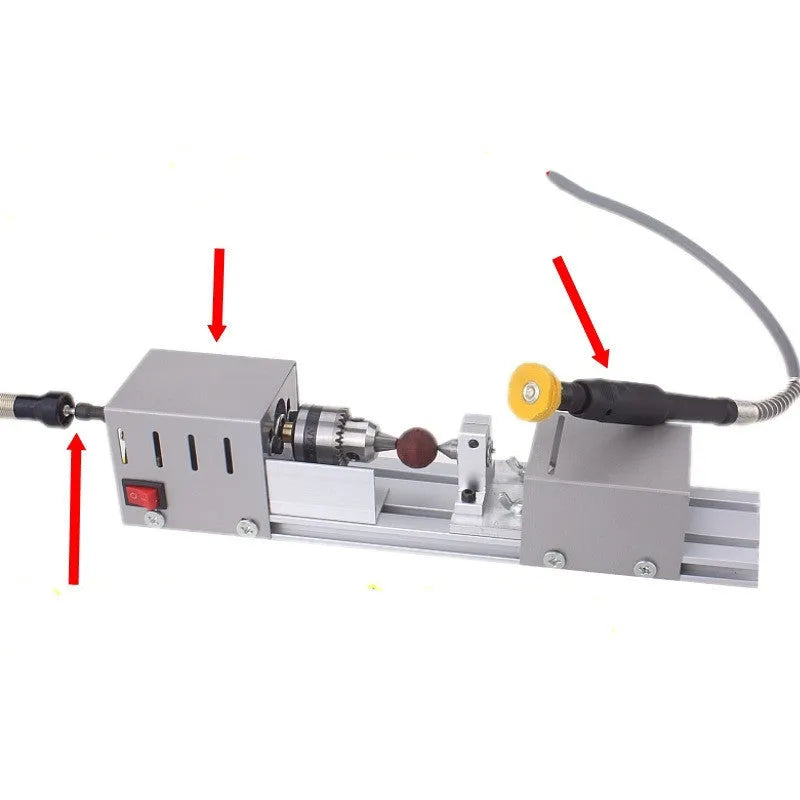Silver metal mini manual woodworking lathe with carving knives on a bench