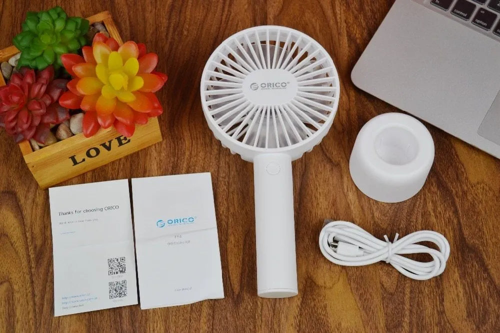White ORICO FH1 portable USB rechargeable fan with three-speed control on desktop