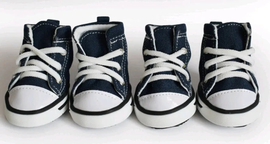 Navy blue denim canvas dog shoe with non-slip sole on a dog
