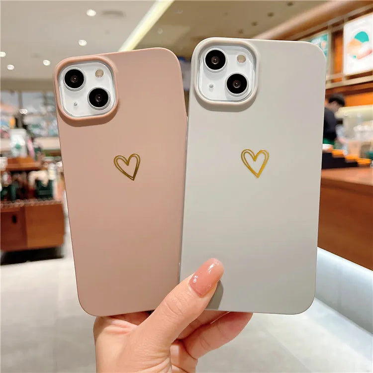 Brown soft silicone iPhone case with a simple cartoon ins style design on a table.