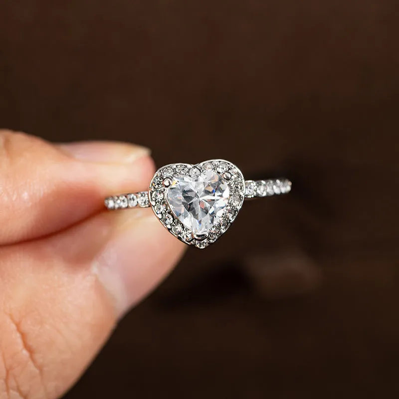 Heart-shaped women's fashion ring with crystal details in rose gold or silvery electroplated finish.