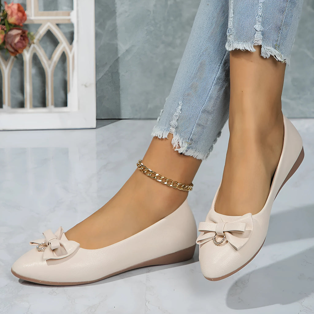 Women's beige casual flat shoes with a bowknot detail and slip-on shallow mouth design.