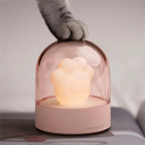Cat paw-shaped night light with music box function showing pink colour option with illuminated soft light
