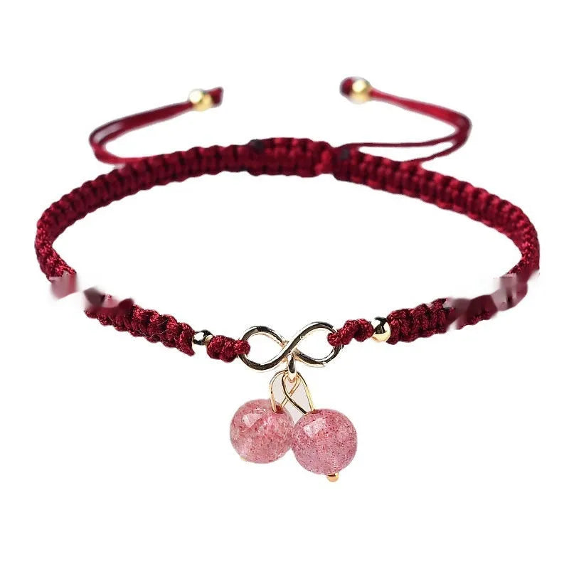 Women's natural strawberry quartz crystal bracelet with red cherry-shaped beads on a string.