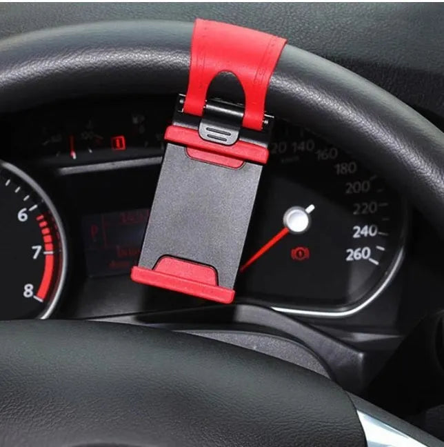 Black universal steering wheel phone holder clip mounted on a car steering wheel.
